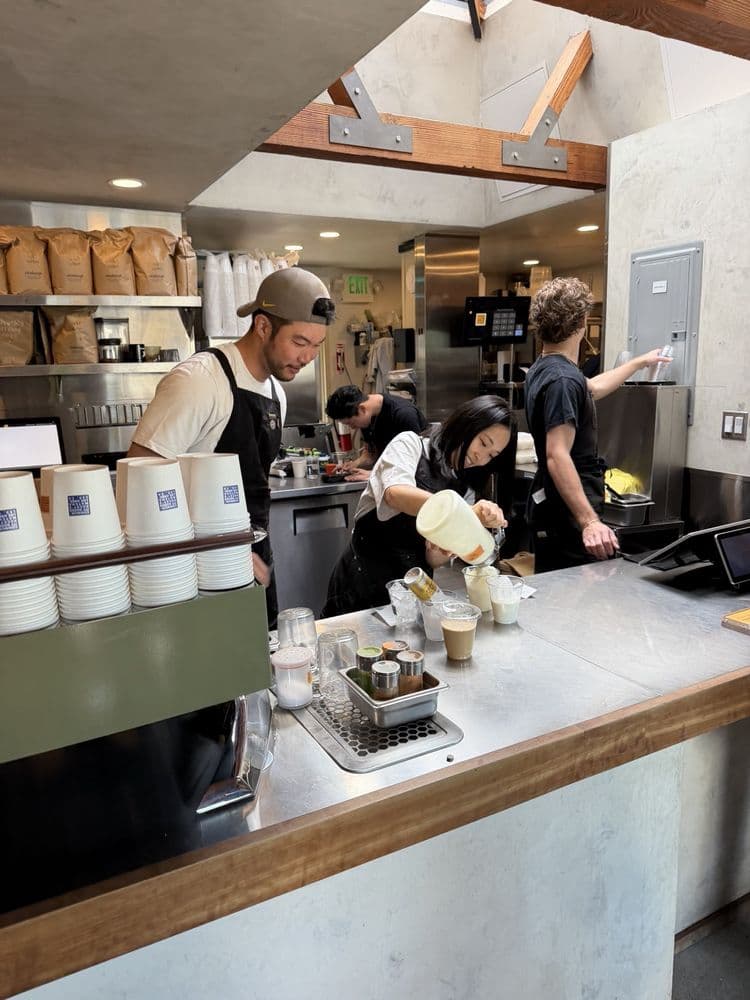 Barista crafting beverages behind the counter